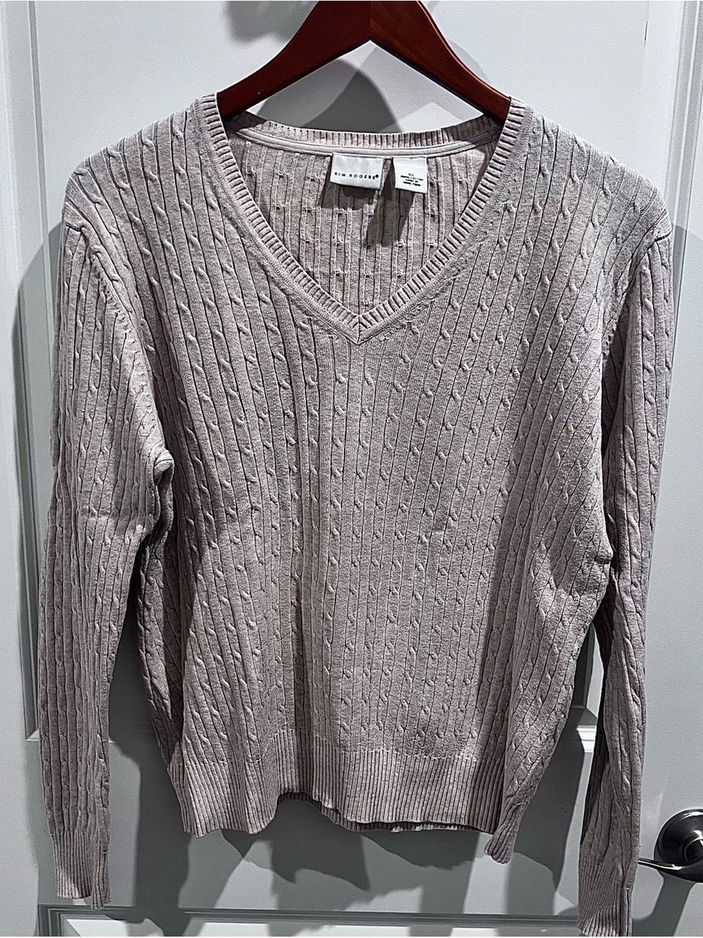 Kim Rogers classic beige cable-knit V-neck pullover sweater.